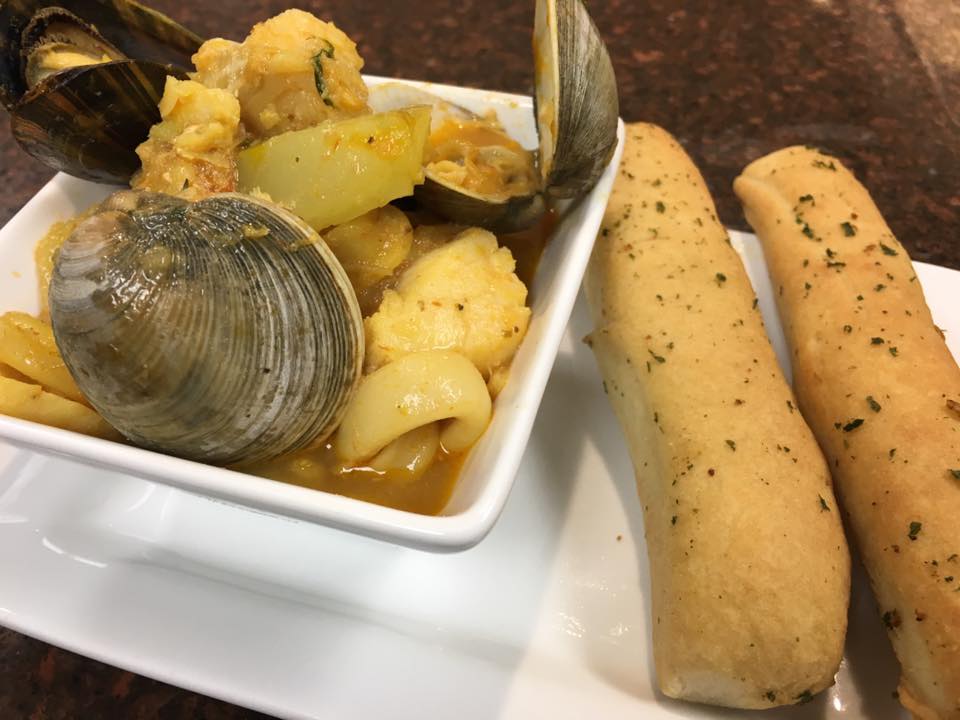 Bouillabaisse with breadsticks.