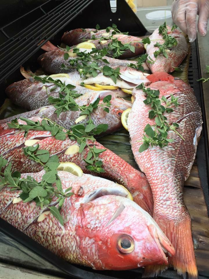 Grilled red snapper over banana leaves.